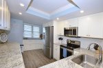 Kitchen with raised ceiling & stainless steel appliances.